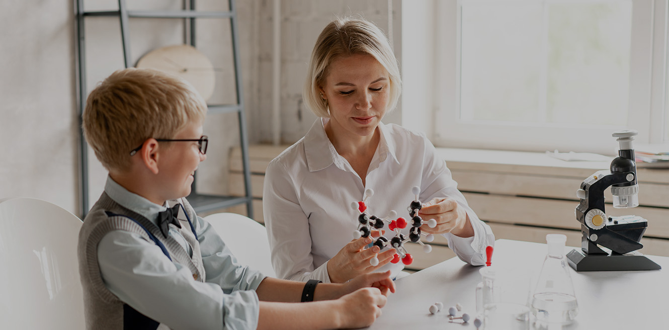 Female science tutor in Philadelphia studying chemistry with student